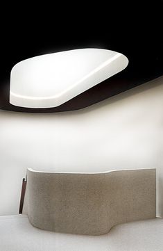 a large white object sitting on top of a table next to a black and white wall