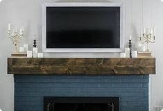 a fireplace with candles and a flat screen tv above it