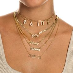 Let the carefree side of your personal style shine bright in Adina's Solid Bubble Name Link Necklace, featuring a cute bubble-font nameplate that dangles from a delicate chain. Customize this gem with the wording of your choice. Pair it with an initial necklace and a couple of cute chokers for a chic, layered look. Product Details Made from Sterling Silver Gold Plated Nameplate Height: 7 MM Chain Thickness: 2 MM Length: 15" +2.5" Capitalized Font This Product Requires 12-18 Business Days To be P Cute Chokers, Nameplate Necklace Gold, Bubble Font, Silver Link Necklace, Nameplate Necklace, Delicate Chain, Graffiti Styles, Letter Charms, Personalized Necklace