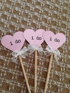 three pink heart shaped lollipops with the words do i do written on them