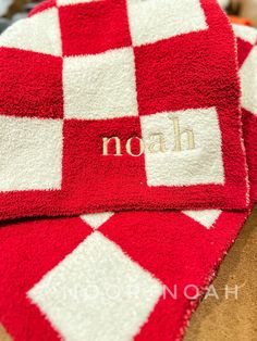 two red and white towels with the word noah on them