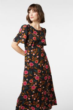 black Modest Short Sleeve Dress For Brunch, Printed Knee-length Midi Dress For Garden Party, Flowy Knee-length Printed Floral Dress, Flowy Knee-length Floral Printed Dress, Modest Flowy Floral Midi Dress, Bohemian Midi Dress For Spring Workwear, Flowy Midi Dress For Work, Flowy Knee-length Midi Dress With Ditsy Floral Print, Floral Embroidered Midi Dress For Garden Party