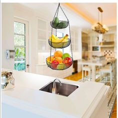 a hanging fruit basket in the middle of a kitchen