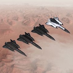 four fighter jets are flying in formation over the desert