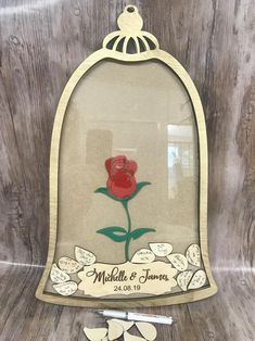 a red rose in a glass case with writing on it