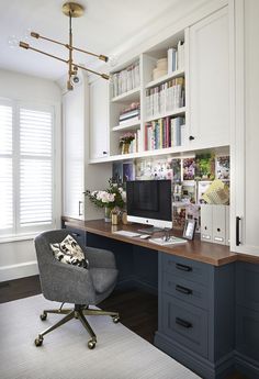 a home office with built - in bookshelves, desk and chair is shown