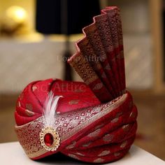 a red and gold hat sitting on top of a table