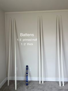 three white poles are in front of a wall with the measurements for each one,