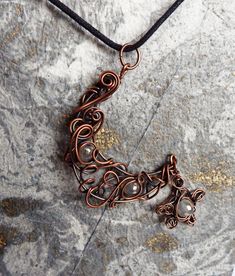 "This Copper Wirework Crescent Moon Necklace with rainbow titanium agate beads and star is such an unusual piece of jewelry and is a real statement piece. It has been oxidised to enhance the twists and turns of the copper wirework and brings out the sparkle of the beads. This will be your next go to necklace and comes on a 18\" cord making it great for layering. Great Gift for your Witchy Friend Original Gift for your wife on your 7th Anniversary together Beautiful Goth Christmas Gift Your penda Unique Handmade Star Necklace, Handmade Moon-shaped Spiritual Jewelry, Handmade Star-shaped Metal Jewelry, Celestial Style Wire Wrapped Pendant Jewelry, Adjustable Magical Pendant Jewelry, Handmade Star-shaped Magical Jewelry, Adjustable Wire Wrapped Magical Jewelry, Bronze Moon Charm For Jewelry Making, Mystical Star-shaped Jewelry With Moon Charm