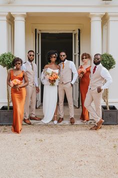 a group of people that are standing in front of a door with flowers on their heads