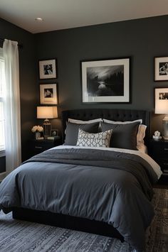 a bedroom with gray walls and pictures on the wall above the bed, along with two lamps