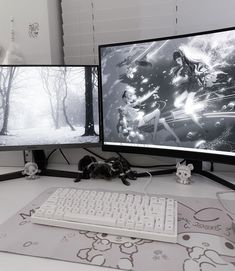 two computer monitors sitting next to each other on top of a white desk with a mouse and keyboard