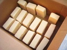 several cubes of cheese sitting in a box