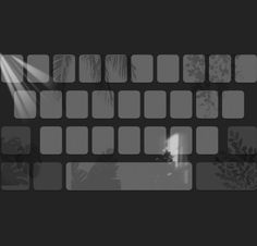 a black and white photo of a keyboard with light coming through the keys on it