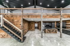 an open floor plan with stairs leading up to the second story