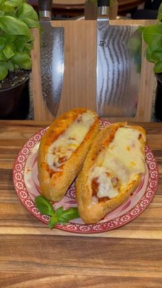 two pieces of bread with cheese and sauce on a plate next to potted plants