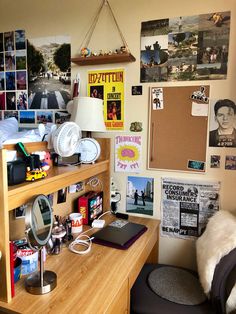 a desk with a chair, lamp and pictures on the wall in front of it