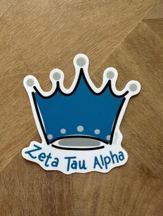 a sticker with the words zeta tau alpha on it and a blue crown