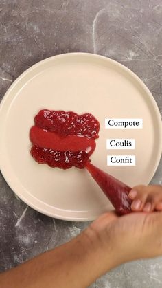 a person is spooning jelly onto a white plate with the words composte, coulis and confit on it