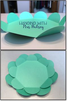 the paper flower is cut out to look like it has been folded into a bowl