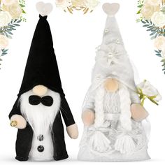 two gnomes dressed in white and black sitting next to each other with flowers around them