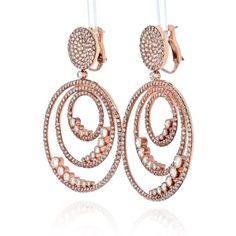 These exquisite 18K Rose Gold Diamond Triple Hoop Earrings are the epitome of luxury and elegance. Adorned with a breathtaking display of 580 round diamonds, totaling over 20 carats, these earrings are a true statement piece. The brilliance and sparkle of the diamonds is unmatched, creating a captivating visual effect that is sure to turn heads.Crafted with meticulous attention to detail, these earrings feature a post with omega backing for secure and comfortable wear. At 2.25 inches long, they Luxury Rose Gold Halo Earrings, Luxury Rose Gold Hoop Earrings With Cubic Zirconia, Luxury Hoop Earrings With Sparkling Stones, Luxury Rose Gold Drop Earrings, Triple Hoop Earrings, Pear Ring, Diamond Birthstone, Tennis Necklace, Rose Gold Metal