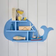 a blue whale shelf with books and toys on it