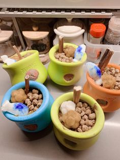 four bowls filled with food sitting on top of a kitchen counter next to an oven