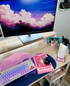 a desktop computer sitting on top of a wooden desk next to a keyboard and mouse