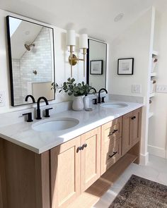 a bathroom with double sinks and mirrors on the wall above them is shown in this image