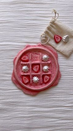 a red tray with hearts on it next to a napkin