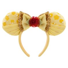 a yellow minnie mouse ears headband with a red rose on it's side