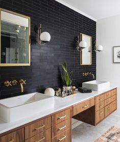 a bathroom with two sinks and mirrors on the wall