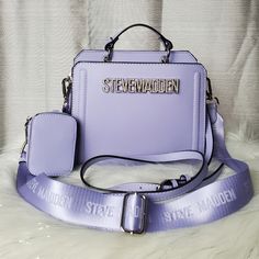 -Gentle Lavender Purple Crossbody Bag With Rhinestone "Steve Madden" Logo On The Front -Has One Nylon Strap And One Faux Leather Strap, Both Are Adjustable/Detachable -Straps Can Be Taken Off And Bag Can Be Used As Handbag -Has Two Different Compartments One Has Magnetic Snap Closure And The Other One Has Zippered Closure -Has Silver Hardware Accents -New With Tags. No Damages -Tiktok Bag Dimensions: W: 9" H: 7 1/4" D: 4 3/4" Purple Birthday Gifts, Luxury Lavender Rectangular Bag, Purple Lifestyle, Crossbody Purse Designer, Purse Outfit, My Style Bags