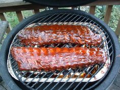 two bbq ribs cooking on the grill with sauce and ketchup being poured over them