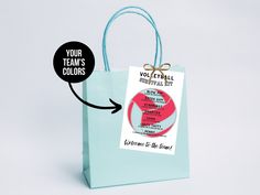 a blue shopping bag with a tag attached to it that says your team's colors