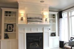 a living room with a fire place and built in bookshelves