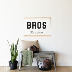 there is a sign that says bros on the wall next to a basket with balls