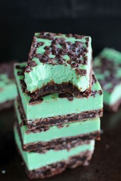 mint chocolate chip fudge brownie bars stacked on top of each other with text overlay