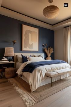 a bedroom with blue walls and white bedding in front of a large painting on the wall