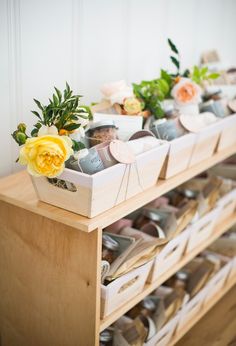 a wooden shelf filled with lots of different types of shoes and flowers on top of it