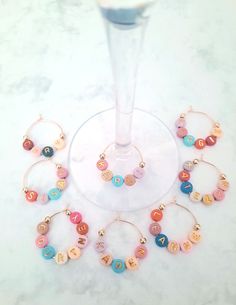 Our colorful and fun personalized glass charms are a perfect gift for all party guests to tag those glasses and then keep as a personalized party favor. These fun custom name glass charms are great for your next upcoming girl's night out, office party, bachelorette party, bridal shower, wedding favors and even stocking stuffers.  Each charm is easy to fasten and easy to remove from the glass. Chams stay on the glass until it is time for removal. The beads are secure and will move around with a l Mimosa Party, Wine Glass Charm, Drink Tags, Mini Champagne, Gift For Wedding, Party Bachelorette, Bridal Shower Gift