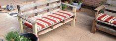 two wooden benches sitting next to each other on top of a cement floor covered patio