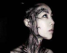 a woman with tattoos on her face and neck