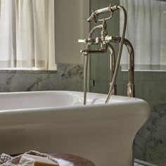 a white bath tub sitting next to a window