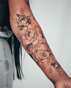 a woman's arm with flowers on it