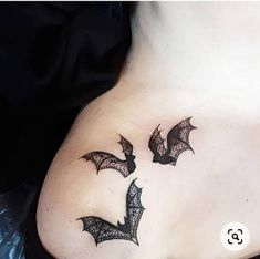 two bats on the back of a woman's stomach, one is black and the other is white