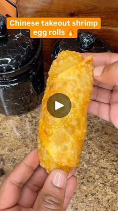 someone is holding an egg roll in their hand and pointing it at the camera, with text that reads chinese takeout shrimp egg rolls