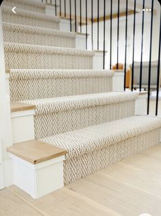 the stairs are lined with white carpet and wood