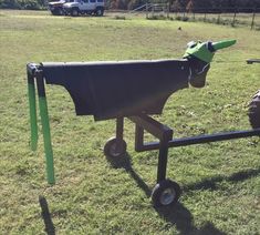 the horse is wearing a green hat on top of it's head and pulling a cart